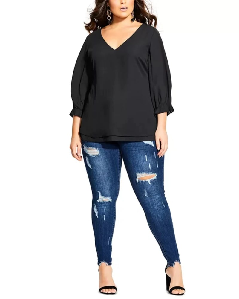 Front of a model wearing a size Petite S City Chic Women's Trendy Plus Size Pleated-Sleeve Top Black Size Petite Small in Black by City Chic. | dia_product_style_image_id:311315